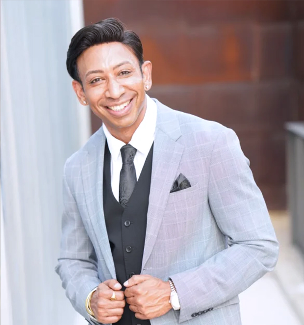Dr. Shiv Goel, board-certified physician at Prime Vitality, smiling in a suit.